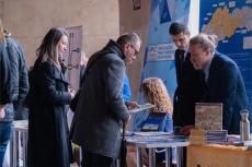 Air quality managers discuss with event visitors